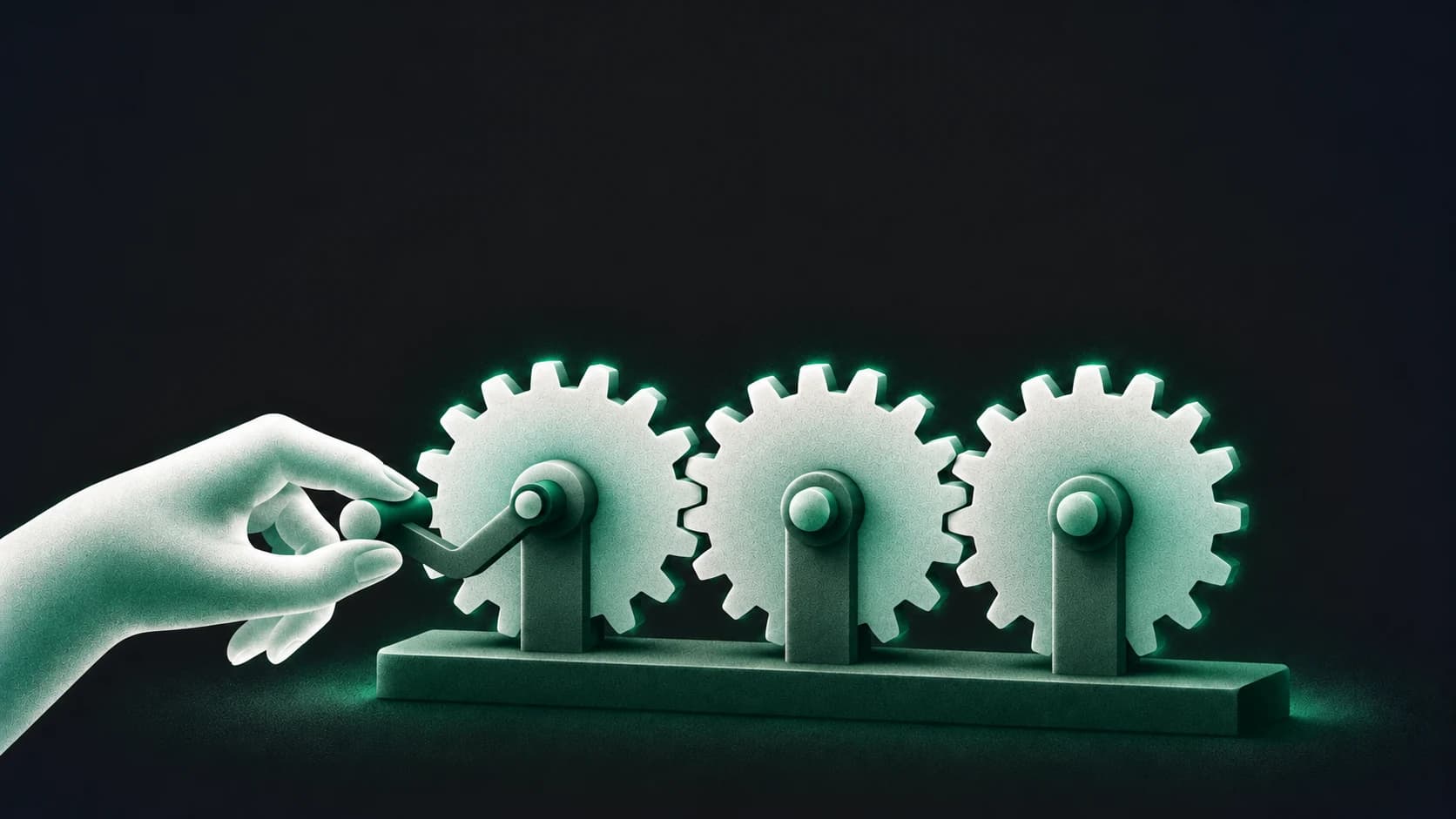 A frosted hand turns one gear in a connected three-gear train.